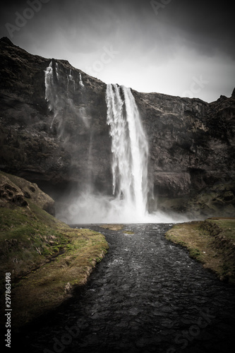 Famous Iceland waterfalls with a clean water on a stony rocky mountain landscape. Toned