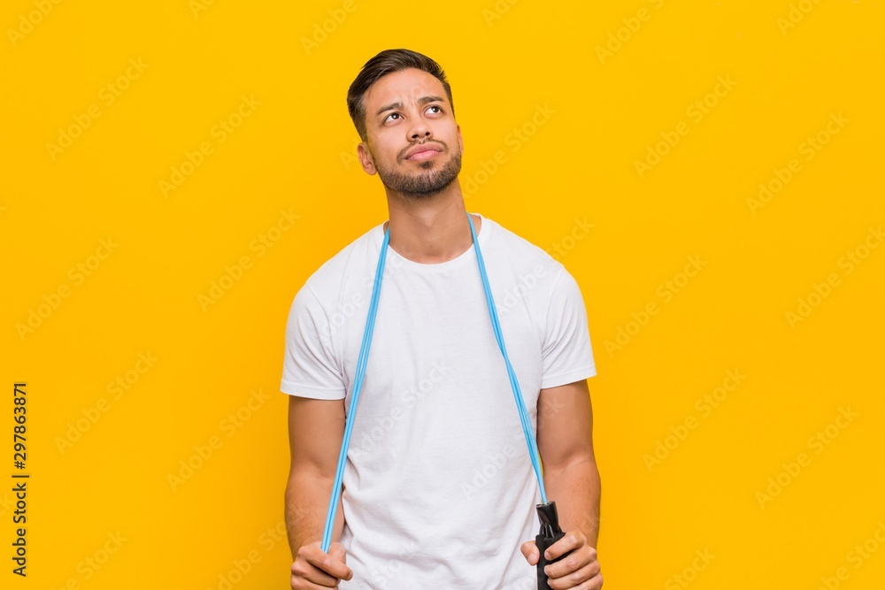 Young south-asian man holding a jump rope. Young south-asian man holding a jump rope.
