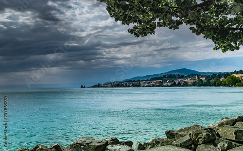 View of the city of Clarens on the shores of Lake Geneva and dark rainy clouds.Montreux,Switzerland.