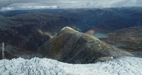 Aerial view from the top of Folgefonna glacier. Drone flight from ice cap to mountain. Norway. photo