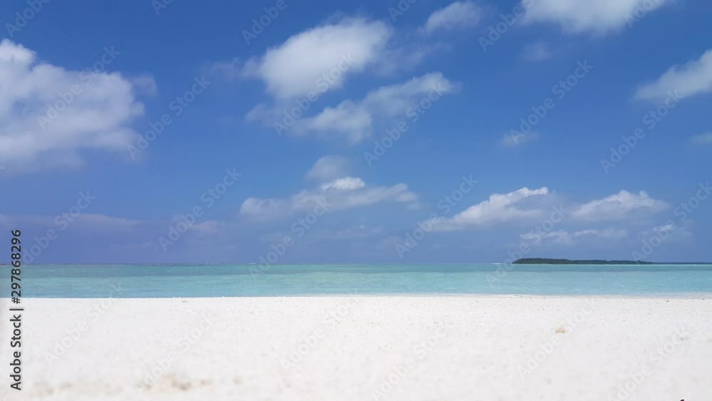 Resting on pure white sand looking out towards clear teal water in Indonesia Resting on pure white sand looking out towards clear teal water in Indonesia