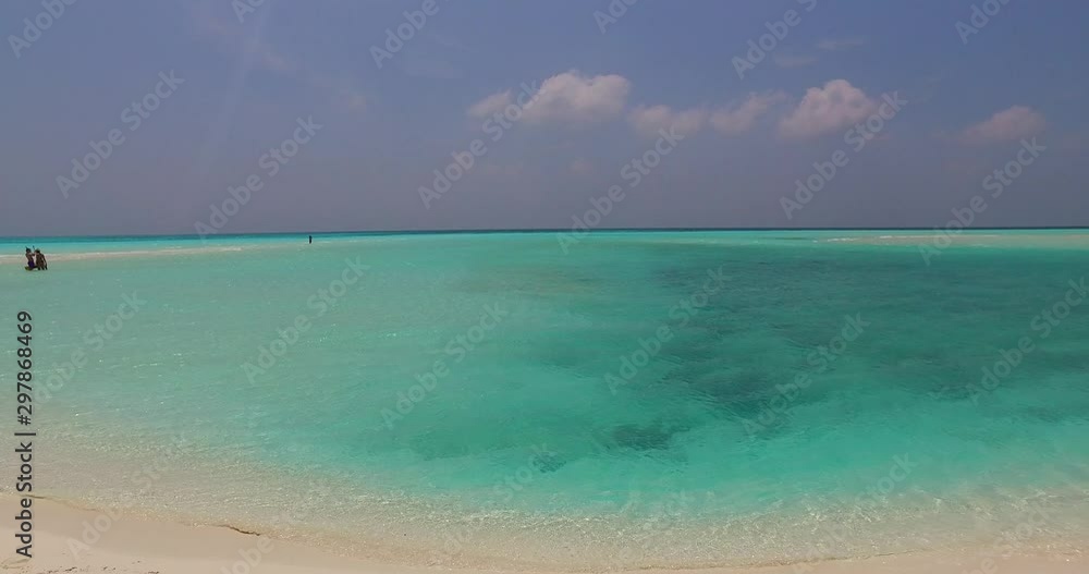 Panning up over vivid tropical water in the Philippines with tourists in the water nearby Panning up over vivid tropical water in the Philippines with tourists in the water nearby