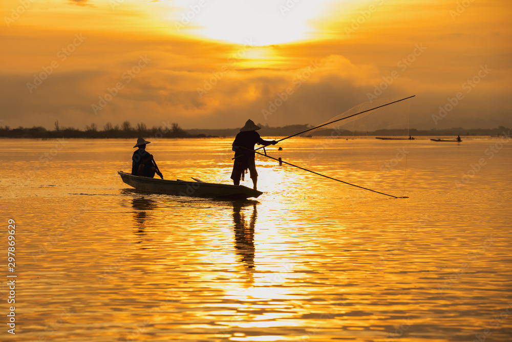 Asian fishermen set sail for fishing on the Mekong River.