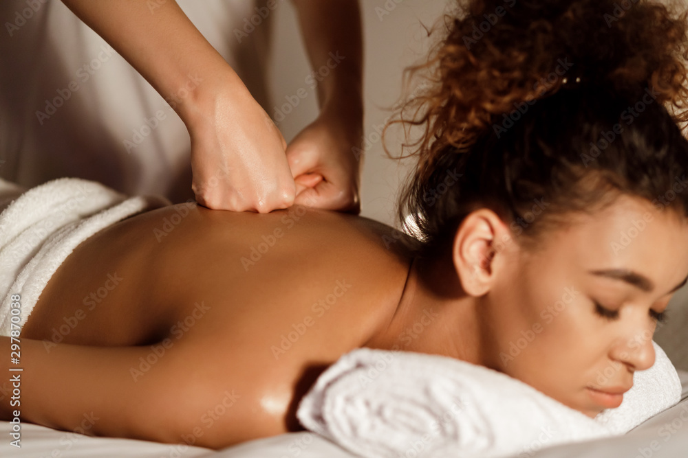 Masseur's hands pressing young woman's back, closeup Masseur's hands pressing young woman's back, closeup