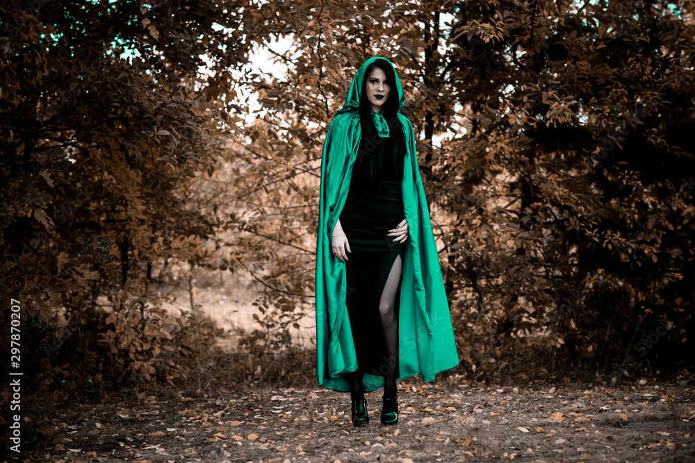 Woman in gothic style wear green carnival cloak, concept of simple Halloween ideas Woman in gothic style wear green carnival cloak, concept of simple Halloween ideas