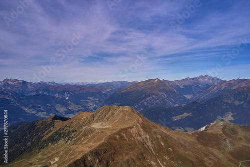 Aerial view of the Alps surrounded by meadows, forests and mountains. Flying on drone. © Berg