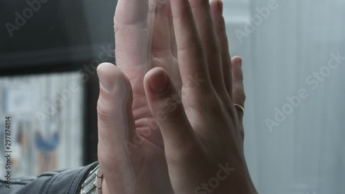 Two hands male and infant teenager girl touching hands through glass. Emotional shot. Father daughter relationship bonding. photo