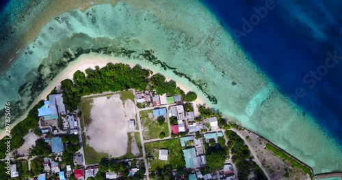 Beautiful Maldivian 5 star hotels and resorts, in the palm forest on small island with swimming pool on white sand beach photo