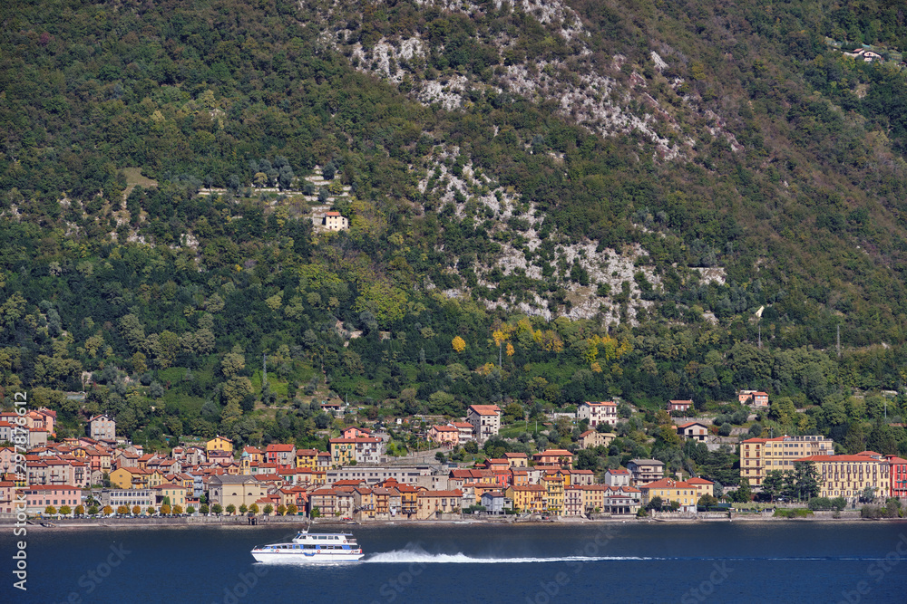 Panoramic view of Lake Como. Lombardy, Italy. Boat in motion on the water. Autumn season.