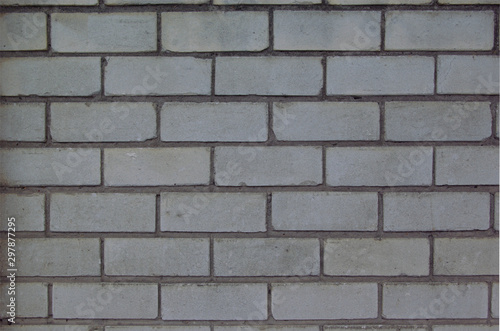 Close up full frame gray brick wall, ideal background or texture at the afternoon