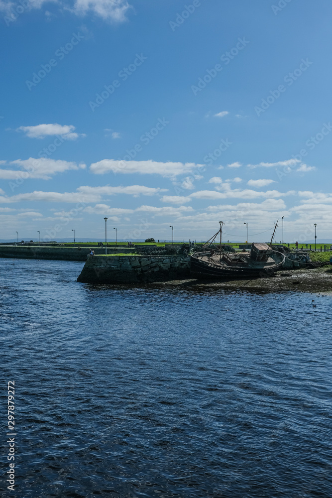 custom made wallpaper toronto digitalView of the River Corrib flowing into Galway Bay, Ireland & the old boats & wrecks on a sunny summer day with blue sky. Taken in the city.