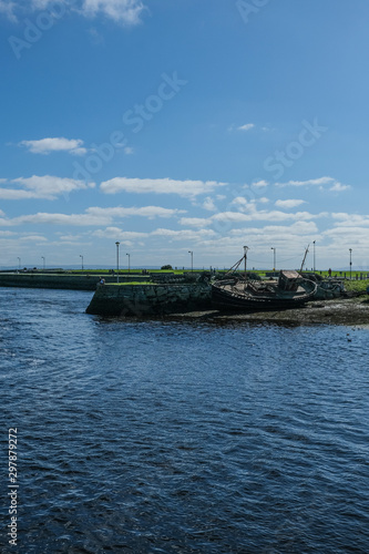 Wallpaper Mural View of the River Corrib flowing into Galway Bay, Ireland & the old boats & wrecks on a sunny summer day with blue sky. Taken in the city. Torontodigital.ca
