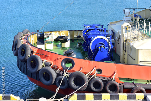 Tug ship bow with large rubber wheels. big tires of the deck of a tug boat. Tire safety bumper on the bow of the tugboat. Tugboat details 