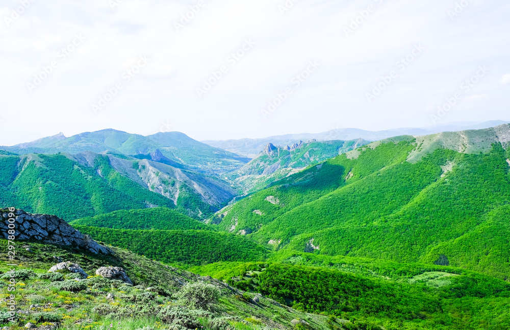Landscape of the Crimean mountains covered with green forests in the summer.