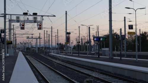 empty train stations with no one on the platforms during evening sunset, panning shot photo