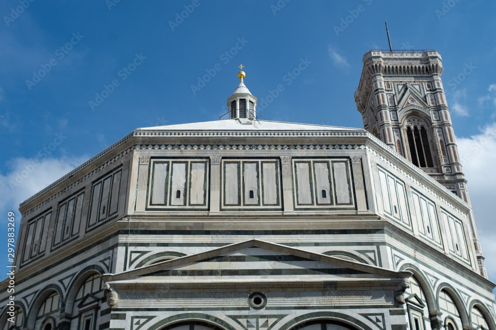 Florence's Santa Maria del Fiore Baptistery with Giotto's tower and blue sky.