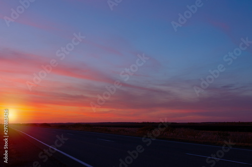 sunset road on a background of colorful sky