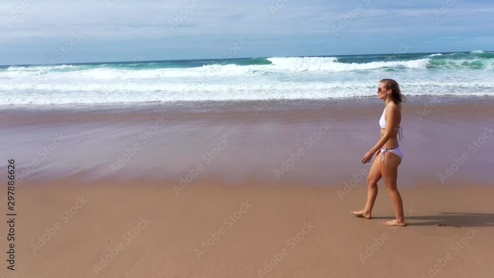 Relaxing summer holiday at the beach - cute girl at the ocean - aerial drone footage Relaxing summer holiday at the beach - cute girl at the ocean - aerial drone footage