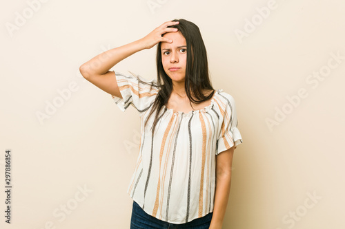 Young hispanic woman being shocked, she has remembered important meeting.
