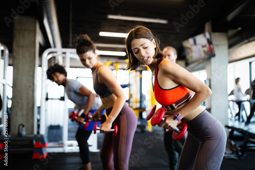 Fitness, sport, training and lifestyle concept. Group of people exercising in gym