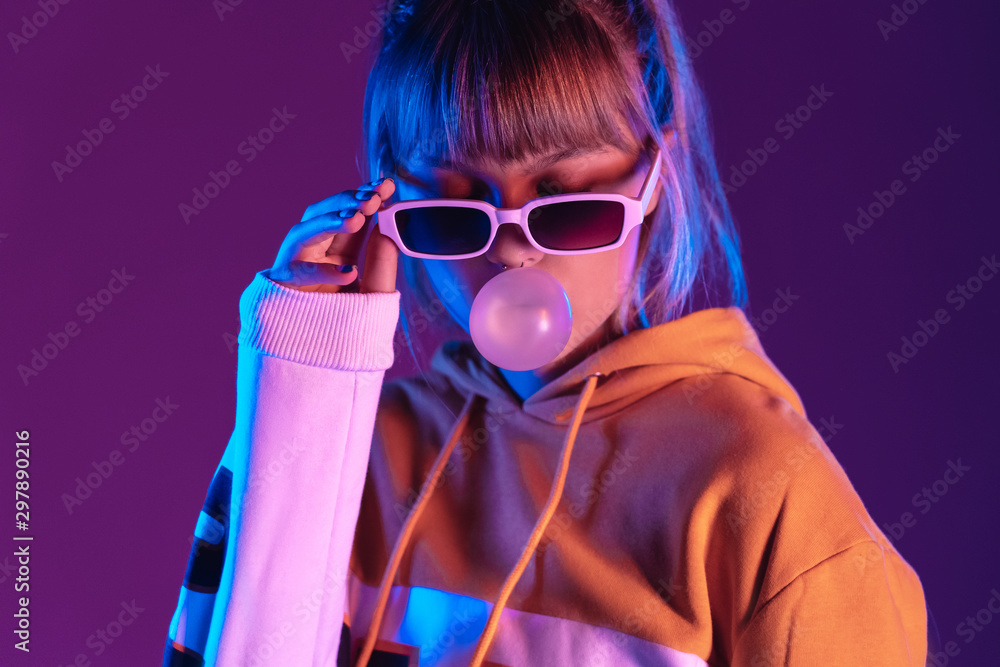 Φωτογραφία Pretty young 20s fashion teen girl model wear stylish glasses hoodie blowing bub