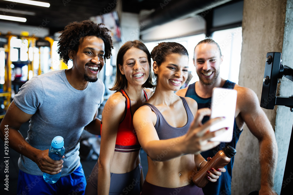Happy fit friends exercising, working out in gym to stay healthy together Happy fit friends exercising, working out in gym to stay healthy together