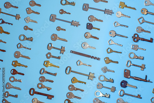 Keys set on blue background. Door lock keys and safes for property security and house protection. Different antique and new types of keys. photo