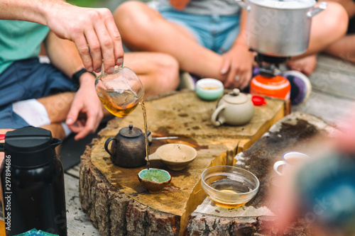 Tea ceremony. Lots of small cups. On an old stump. Health. On nature