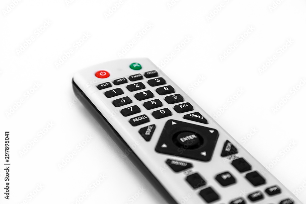 TV remote control close up on white, sharp details, blurred background TV remote control close up on white, sharp details, blurred background