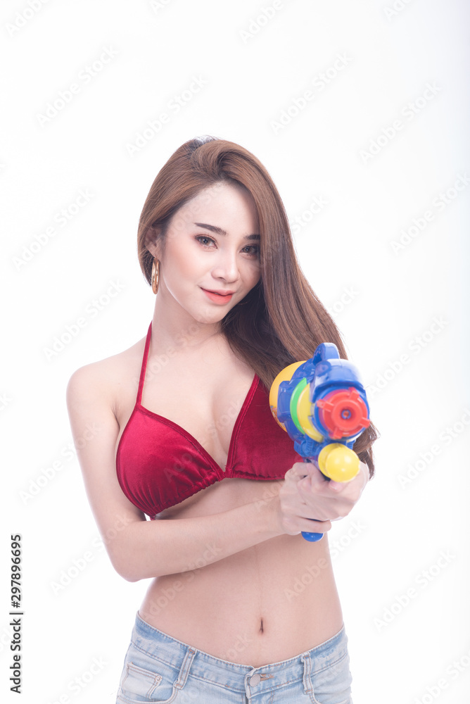 Beauitful young asian woman holding water gun and smile Beauitful young asian woman holding water gun and smile