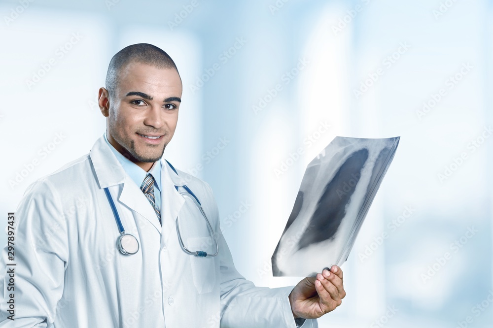 Young man doctor holding stethoscope Young man doctor holding stethoscope