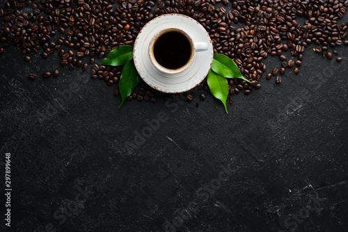 Cup of fragrant black coffee. On a black stone background. Top view. Free space for your text.
