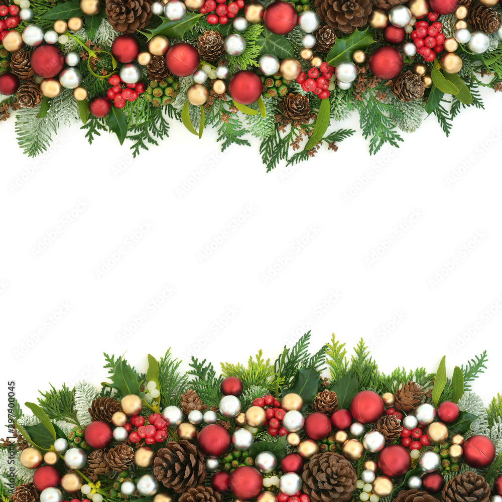 Christmas background border with red, silver and gold bauble decorations and winter flora with pine cones on white with copy space. Christmas background border with red, silver and gold bauble decorations and winter flora with pine cones on white with copy space.