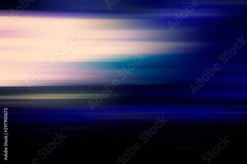 Abstract blurred background of multicolored horizontal lines of light and blue spots.