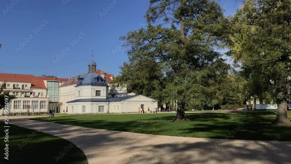 Reconstructed historic blue spa building in Turcianske Teplice, Slovakia, Europe behind the trees in the park. Blue bath building. Reconstructed historic blue spa building in Turcianske Teplice, Slovakia, Europe behind the trees in the park. Blue bath building.