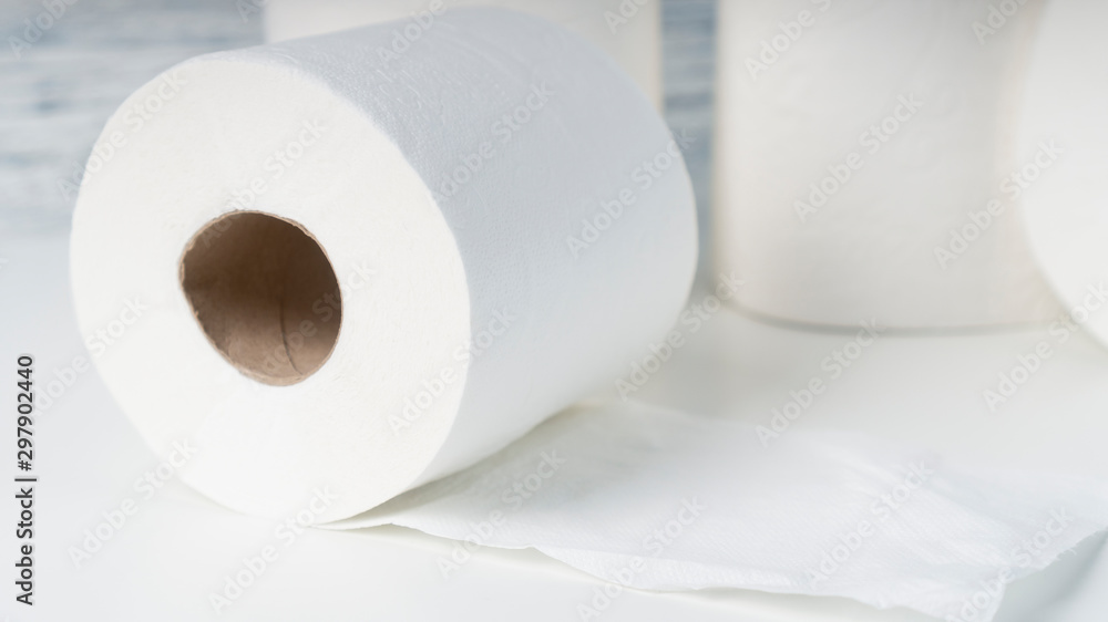 Several rolls of toilet paper on a white table. Hygiene concept Several rolls of toilet paper on a white table. Hygiene concept