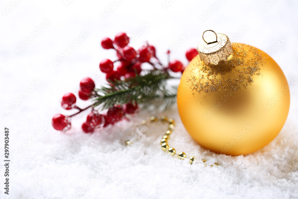 Christmas bauble with red berries on white snow Christmas bauble with red berries on white snow