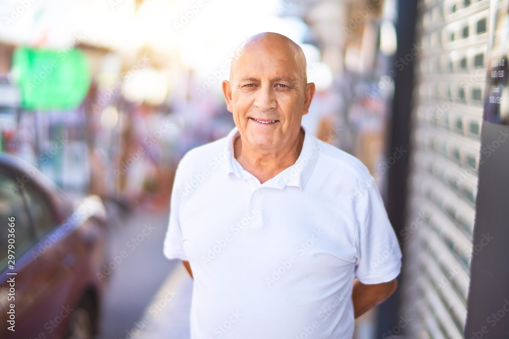 Senior handsome man smiling happy and confident. Standing with smile on face at town street Senior handsome man smiling happy and confident. Standing with smile on face at town street