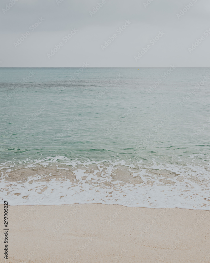 sunrise on the coast of the Mediterranean sea that breaks its waves on the beach of the island mallorca sunrise on the coast of the Mediterranean sea that breaks its waves on the beach of the island mallorca