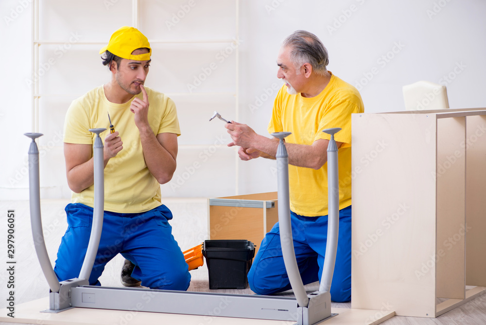 Two contractors carpenters working indoors Two contractors carpenters working indoors