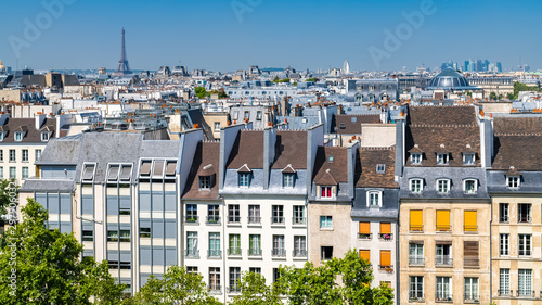 Paris, typical buildings and roofs in the Marais, aerial view from the Pompidou Center, with the Eiffel Tower in background 