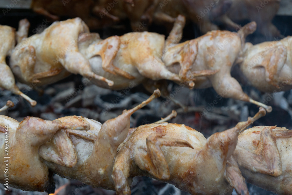 Thai style roasted chicken on the rotation charcoal stove.