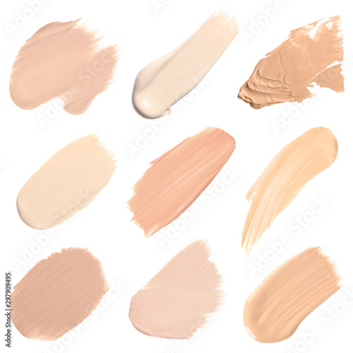 Set of different foundation shades on white background, top view