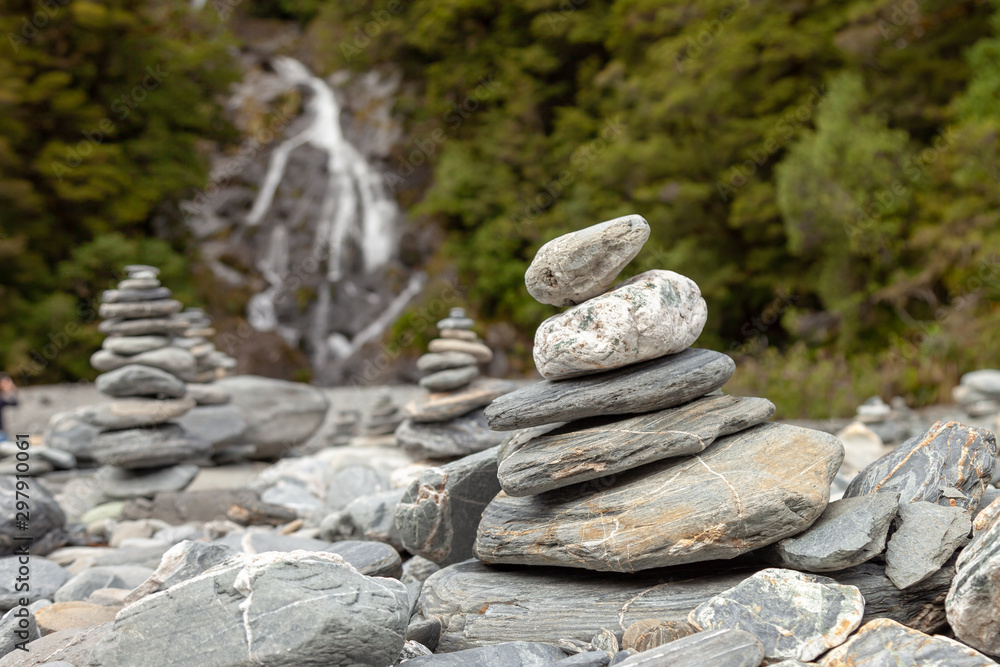 Pile of rocks that mark the way for hikers along a river.