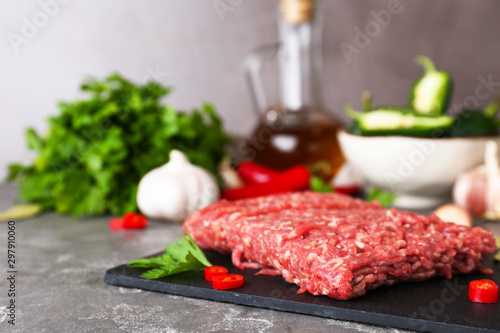 Fresh raw minced meat on grey table