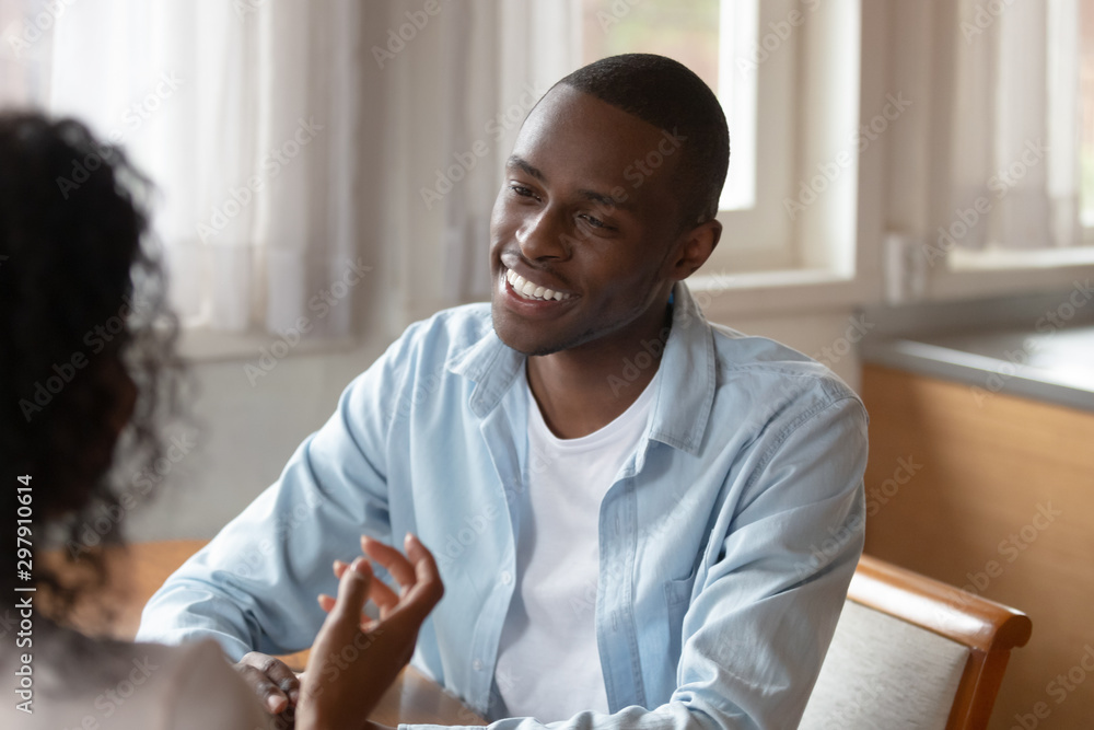 Happy african american man discussing family household issues with wife. Happy african american man discussing family household issues with wife.