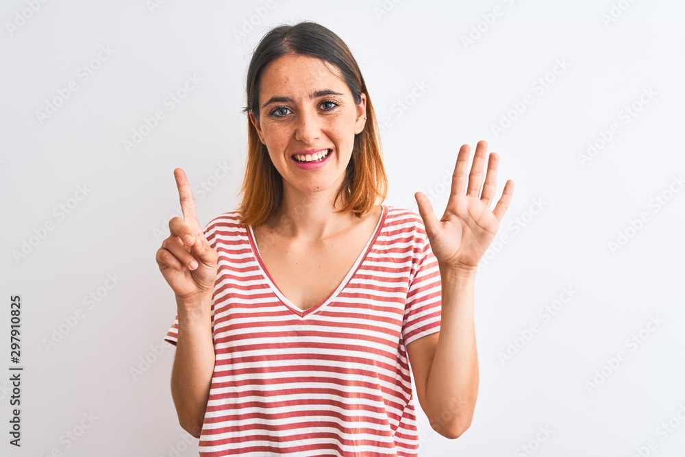 Beautiful redhead woman wearing casual striped red t-shirt over isolated background showing and pointing up with fingers number six while smiling confident and happy. Beautiful redhead woman wearing casual striped red t-shirt over isolated background showing and pointing up with fingers number six while smiling confident and happy.