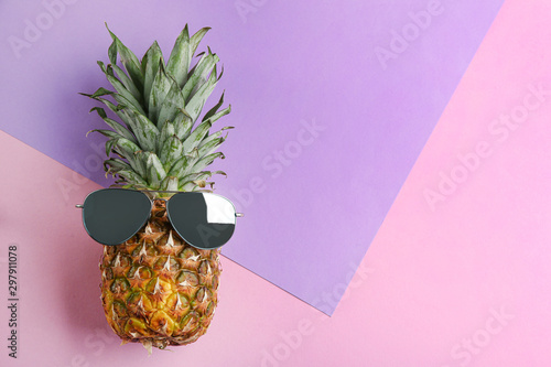 Funny face made of pineapple and sunglasses on color background, top view with space for text. Vacation time