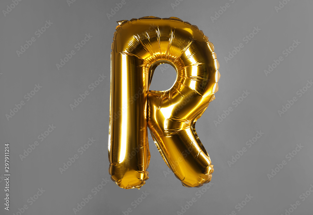 Golden letter R balloon on grey background
