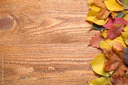 Flat lay composition with autumn leaves on wooden background. Space for text